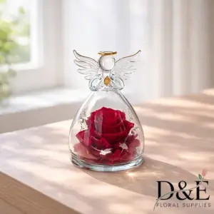 Red preserved rose displayed inside an angel glass bottle